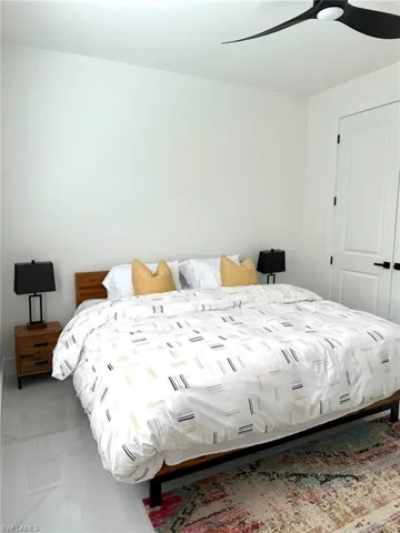 Bedroom with a ceiling fan and a closet