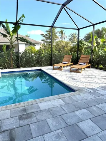 Outdoor pool with glass enclosure and a sunroom