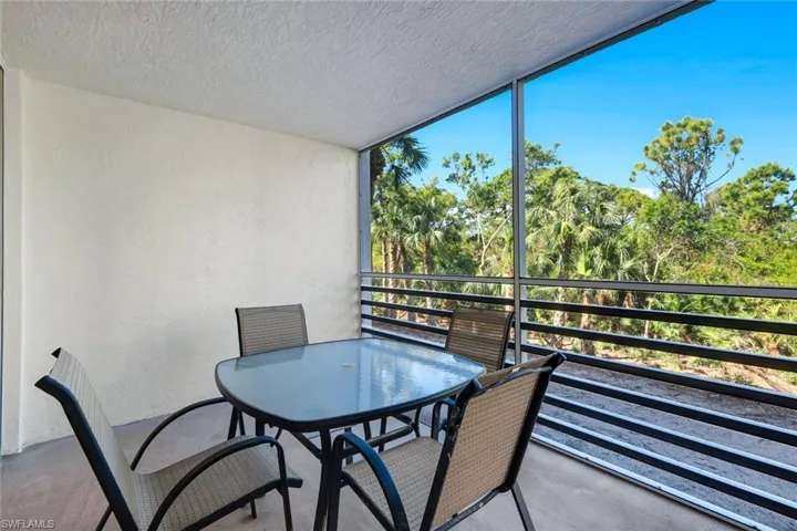 Screened patio with textured white walls and concrete flooring