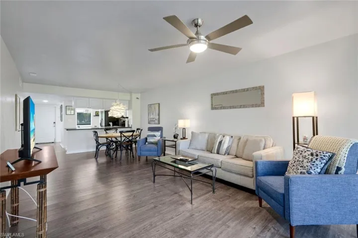 Open concept living area with wood-finish flooring