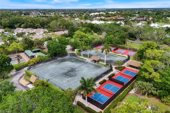 Sporting facilities featuring multiple tennis courts, pickleball courts, and shuffleboard courts
