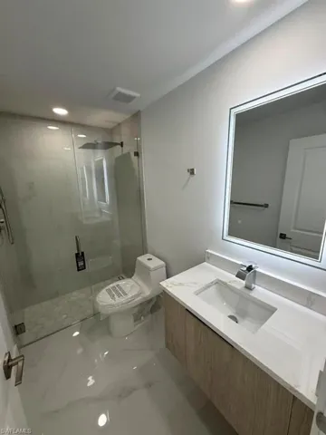 Modern bathroom featuring a floating vanity with a white countertop and integrated sink