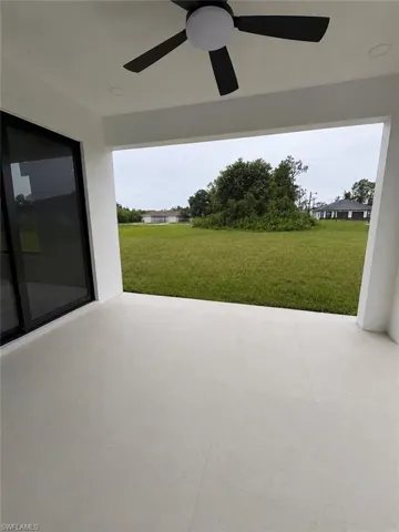 Covered patio featuring large formablob:https://web.whatsapp.com/d4a93732-53ad-4200-b1fb-37279b68ef2at light-toned tile flooring, a contemporary ceiling fan with integrated lighting, and recessed ceiling lighting
