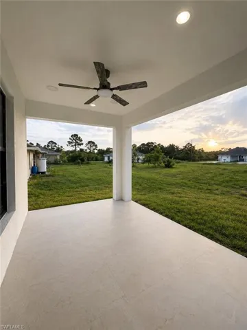 Covered patio featuring large format tile flooring, recessed lighting, and a ceiling fan