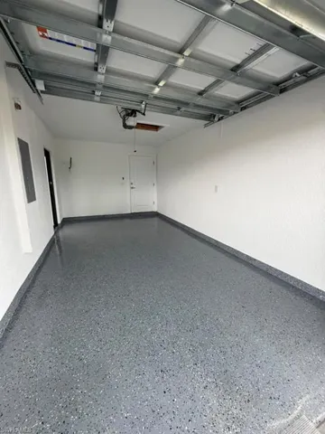 Spacious garage featuring a durable, speckled epoxy floor finish