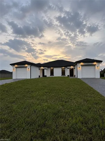 Modern exterior with white stucco finish and black trim