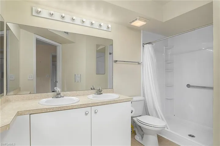 Bathroom featuring a sink, visible vents, and a shower with curtain