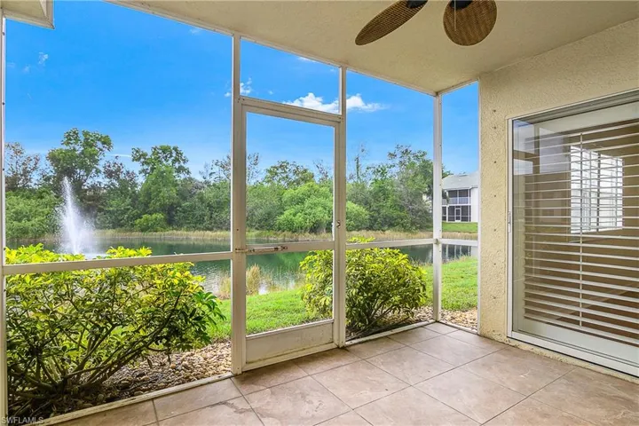 Unfurnished sunroom with a ceiling fan, plenty of natural light, and a water view
