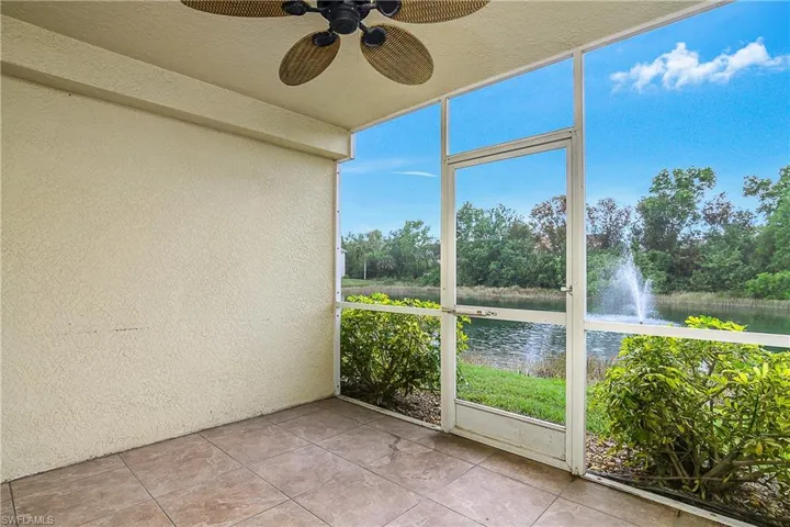 Unfurnished sunroom with a water view and ceiling fan