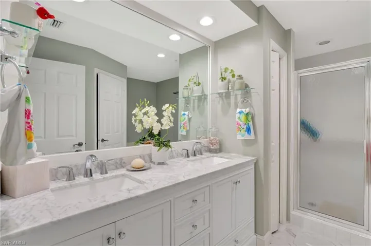 Updated Bathroom featuring an enclosed shower and vanity