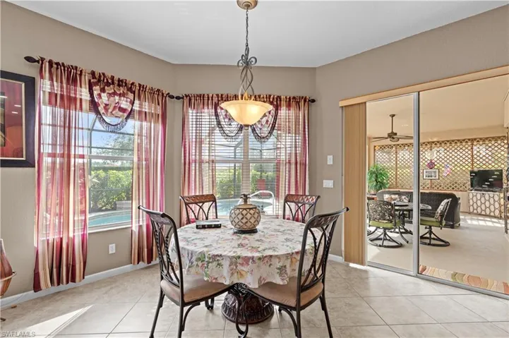 Dining area with ceiling fan and light tile patterned floors