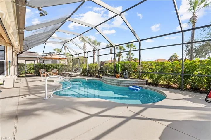 View of pool with a lanai and a patio area