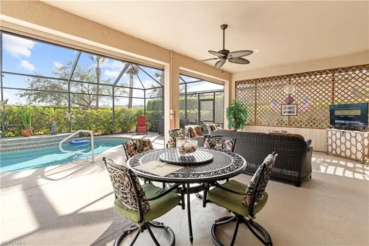 Sunroom / solarium featuring ceiling fan and a swimming pool