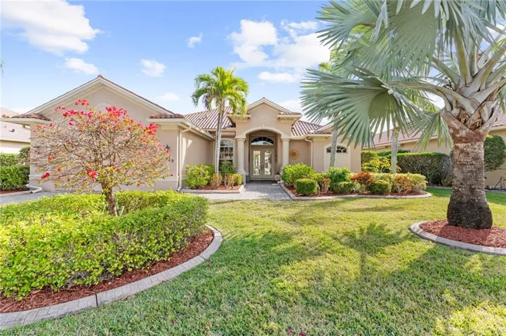 Mediterranean / spanish home featuring a front lawn and french doors