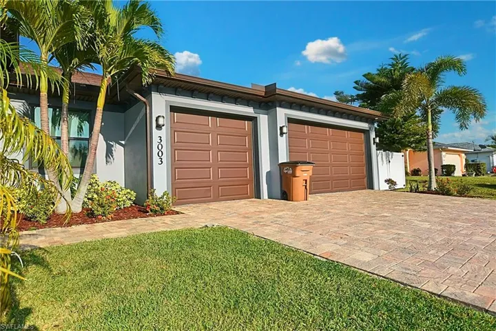 Garage featuring a lawn