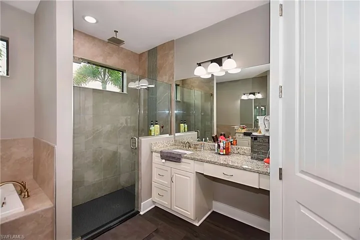 Bathroom with separate shower and tub, wood-type flooring, and vanity