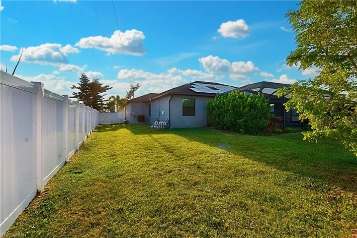 View of yard with screened enclosure