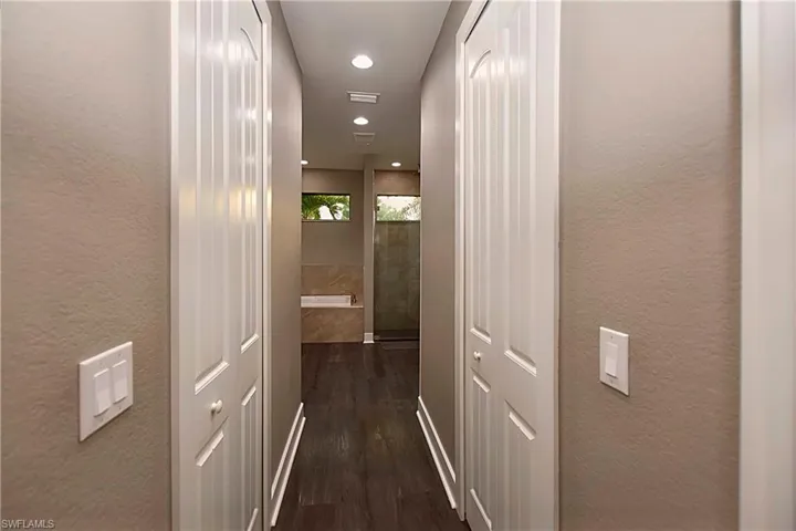 Corridor featuring dark wood-type flooring