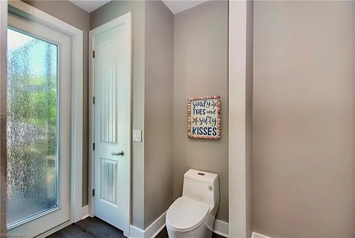 Bathroom with wood-type flooring and toilet