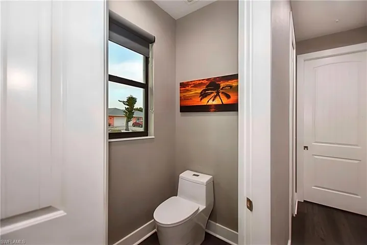 Bathroom with wood-type flooring and toilet