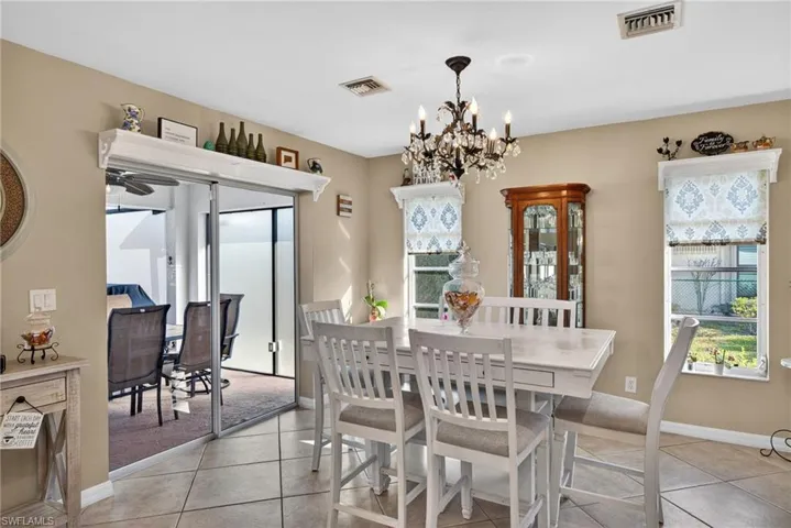 Dining room featuring hanging lights and light tile patterned floors