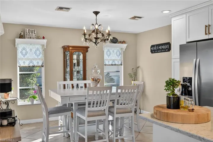Dining area featuring light tile patterned floors and a chandelier