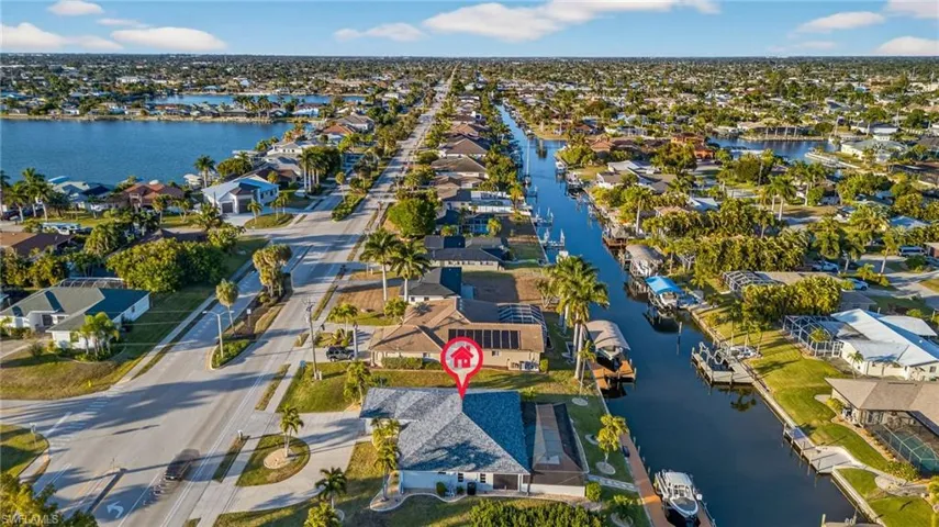 Aerial overview of property's location with nearby suburban area and a nearby body of water