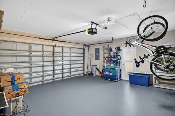 Garage with electric panel and a garage door opener
