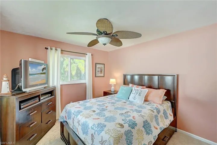 Bedroom featuring light carpet and a ceiling fan