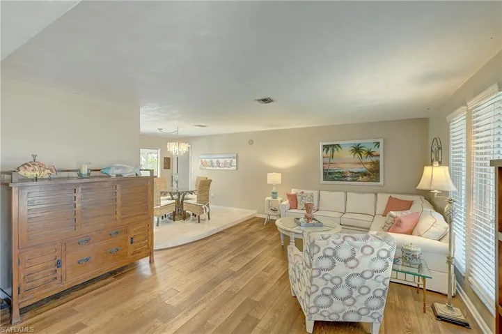 Living area with light wood finished floors and a chandelier