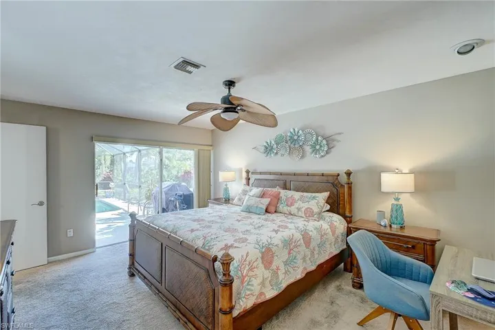 Bedroom with access to outside, carpet flooring, and ceiling fan