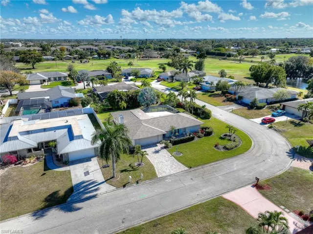 Aerial perspective of suburban area featuring a golf club