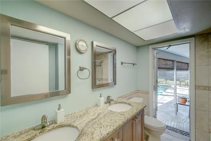 Bathroom with double vanity and tile walls