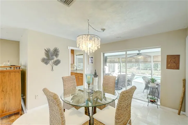 Dining room featuring a chandelier and a ceiling fan