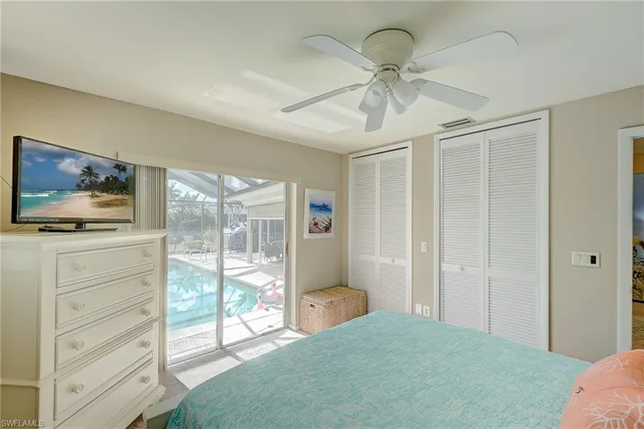 Bedroom featuring two closets, access to outside, and ceiling fan