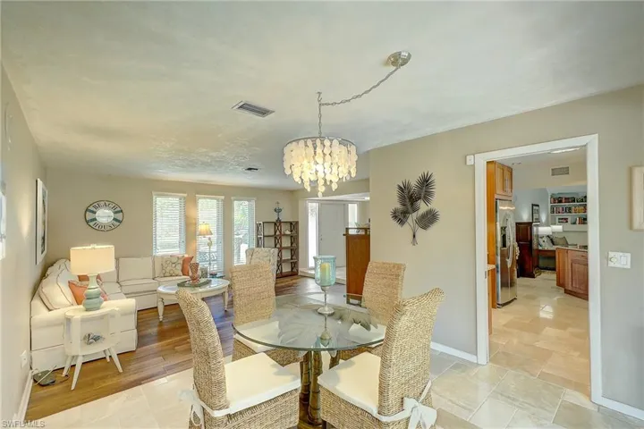 Dining area with a chandelier and baseboards