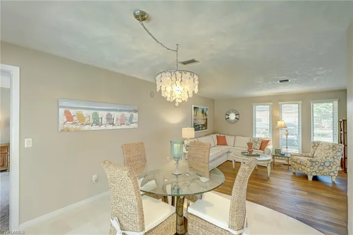 Dining room featuring a chandelier and baseboards