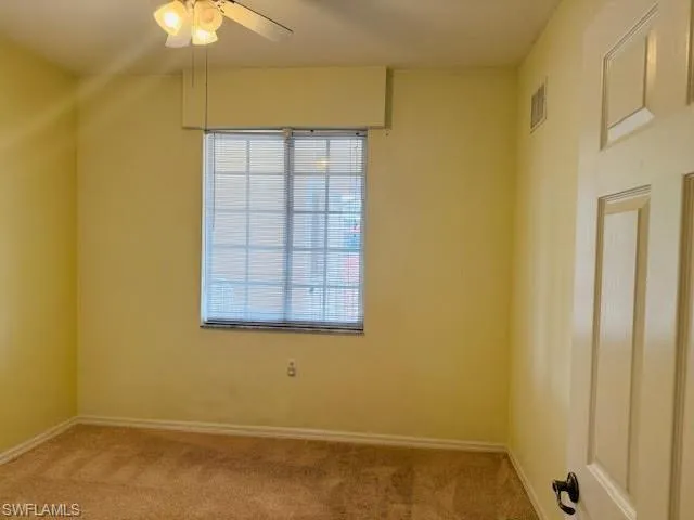 Unfurnished room with carpet and ceiling fan