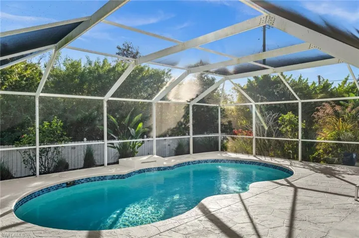 Outdoor pool with a lanai and a sunroom