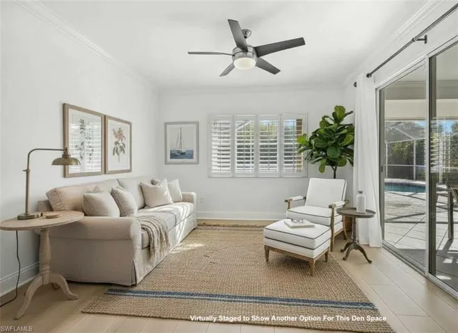 Living room with ornamental molding and ceiling fan