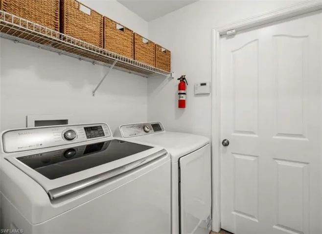 Laundry room with washing machine and clothes dryer