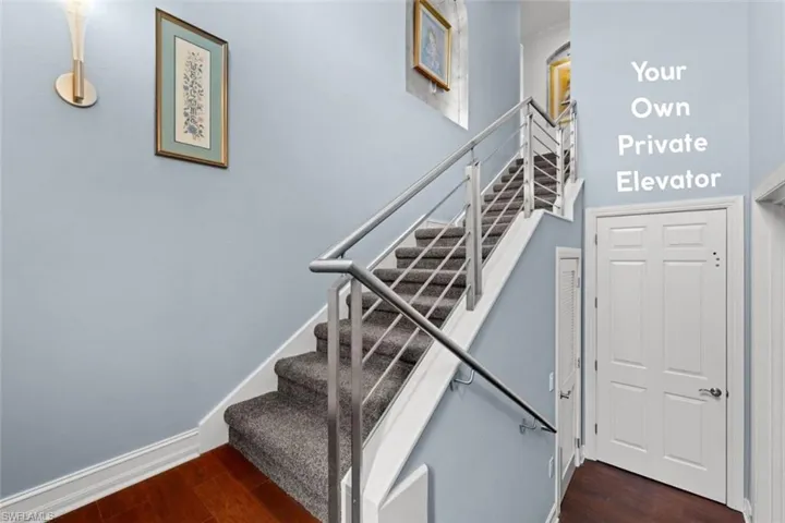 Stairway featuring wood finished floors and baseboards