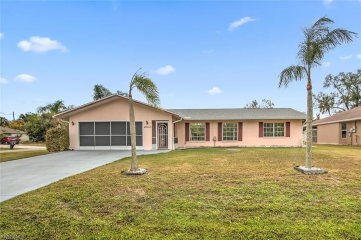 Single story home with a front yard and a garage
