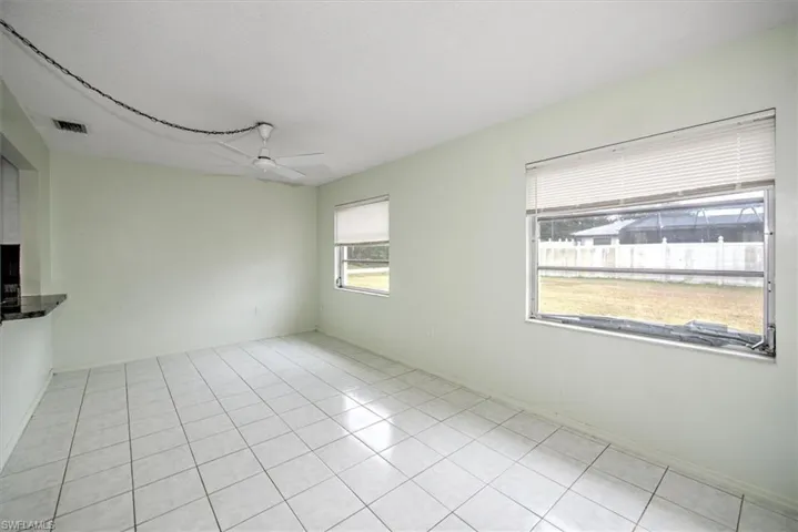 Unfurnished room featuring ceiling fan and light tile patterned flooring