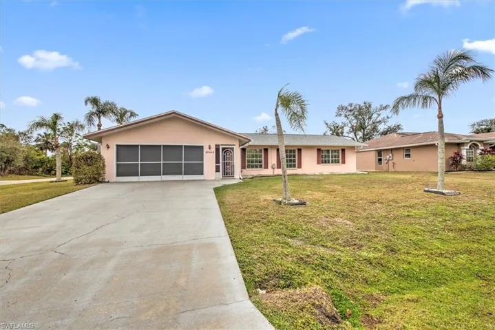 Ranch-style house with a front lawn and a garage
