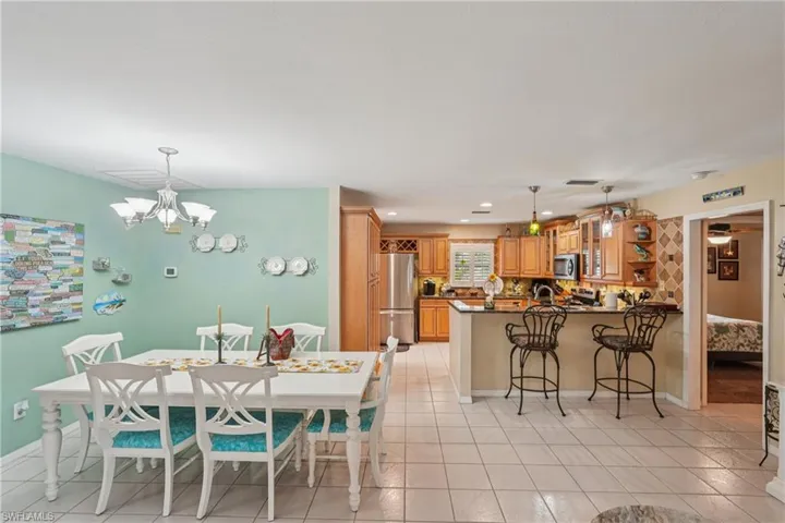 Dining room featuring light tile patterned floors, a chandelier, and recessed lighting