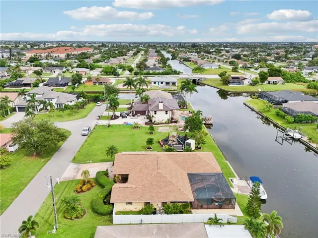 Aerial view of residential area featuring a large body of water