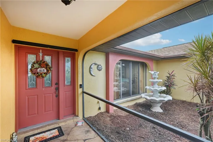 Entrance to property featuring stucco siding