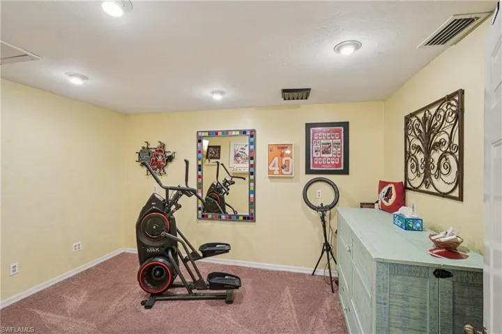 Workout room with carpet and baseboards