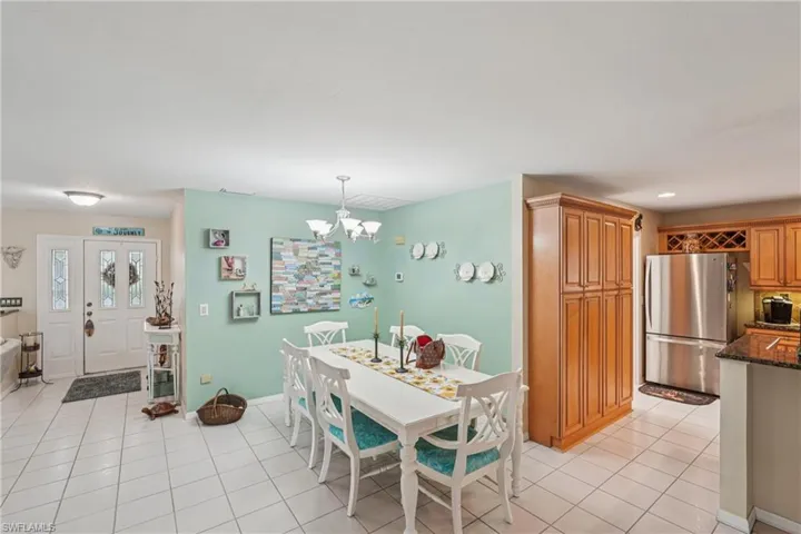 Dining space featuring light tile patterned floors and a chandelier